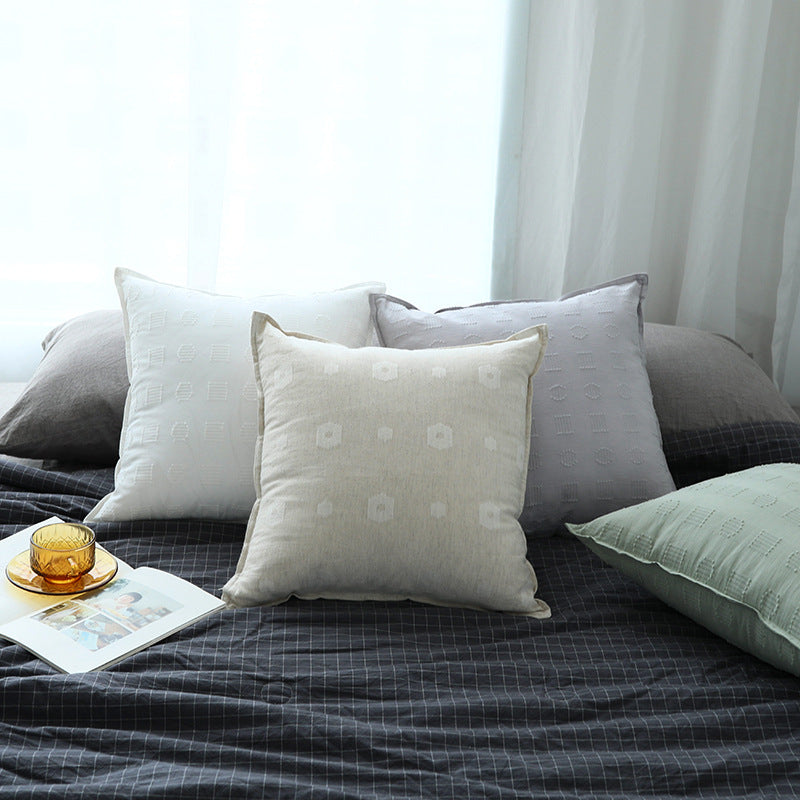 Square decorative cushion cover with subtle tufted geometric relief and piping