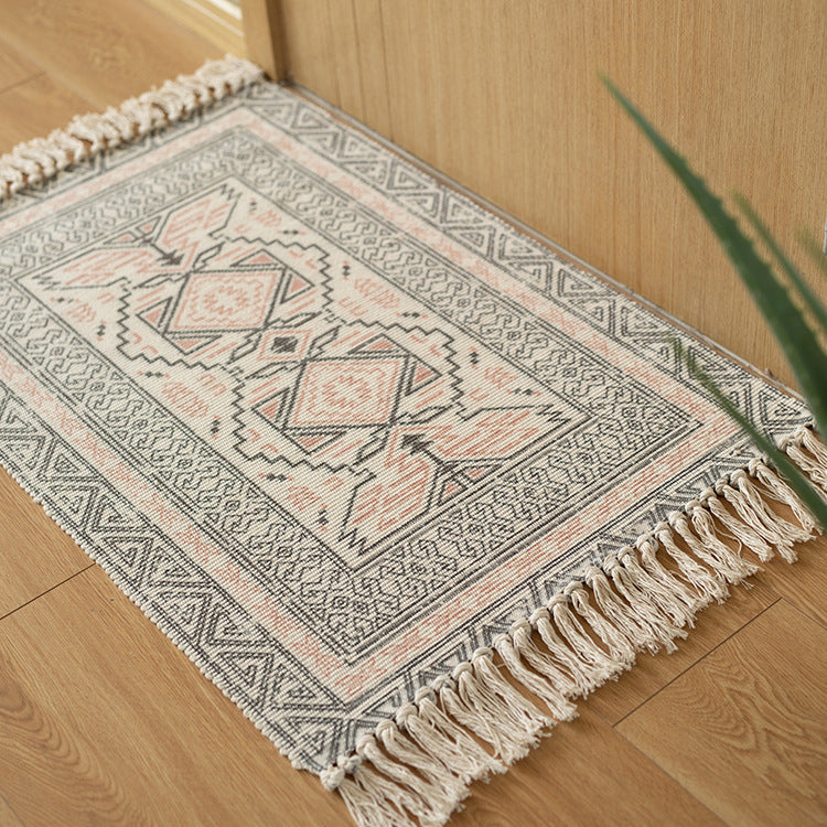 Flat woven runner in ethnic medallion style made of cotton-linen blend with hand-knotted fringes