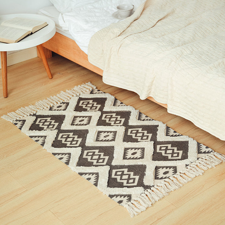 Flat woven runner in ethnic medallion style made of cotton-linen blend with hand-knotted fringes