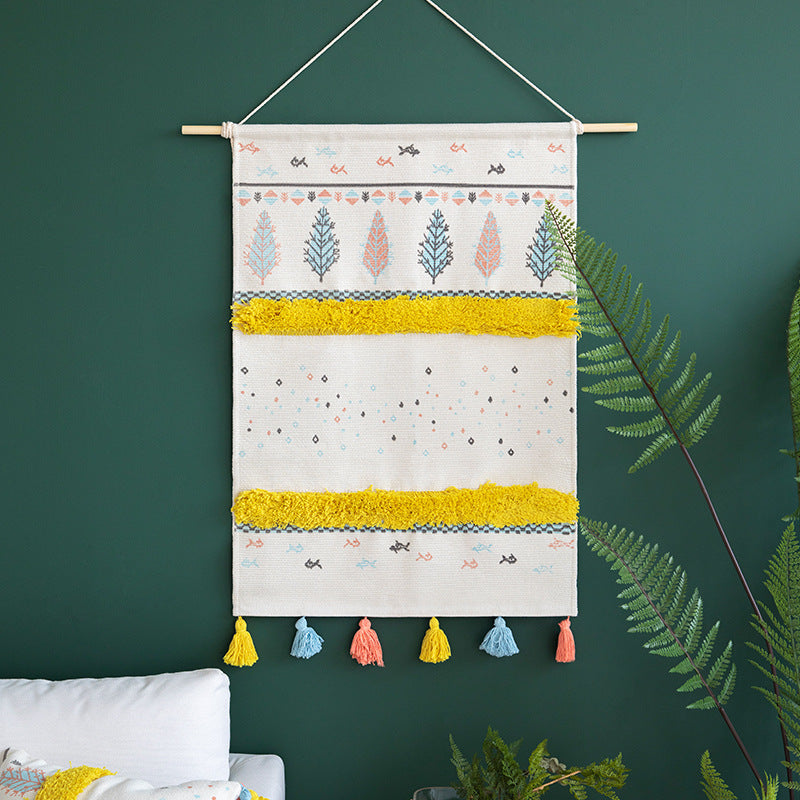 Woven wall hanging with tufted stripes, embroidered leaves, and tassels