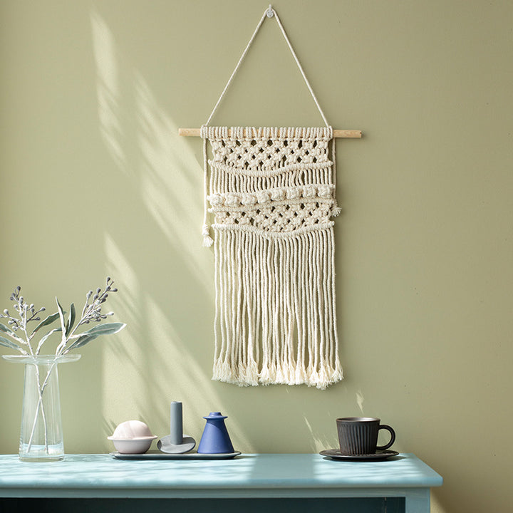 Handmade macrame wall hanging with long tassels and wooden rod