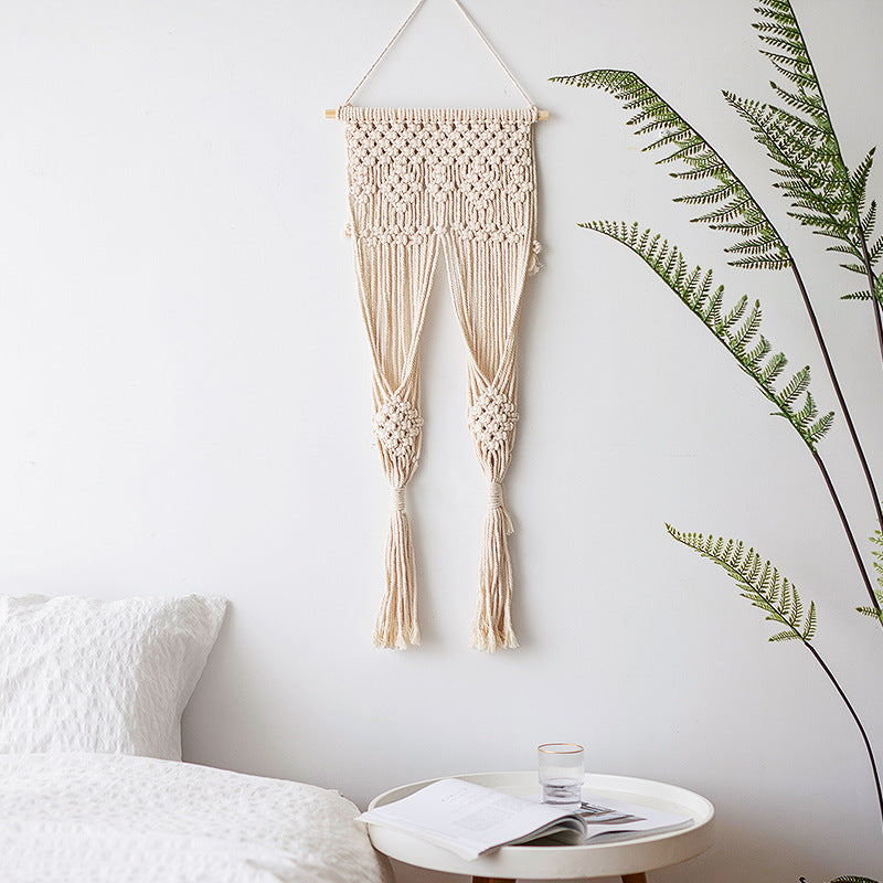 Handmade macrame wall hanging with long tassels and wooden rod