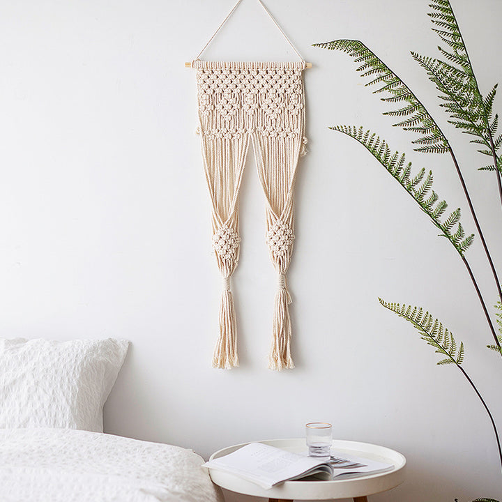 Handmade macrame wall hanging with long tassels and wooden rod