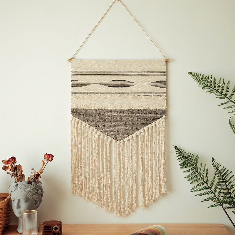 Handwoven wall hanging made of cotton blend with layered textures, wood rod and long fringes Kalsten