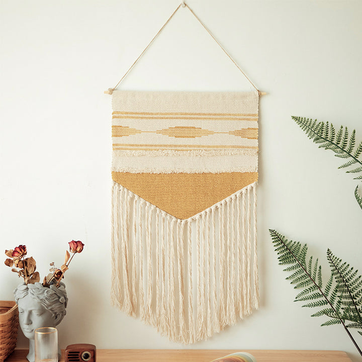 Woven wall hanging in Aztec style with cotton fringes and wooden rod