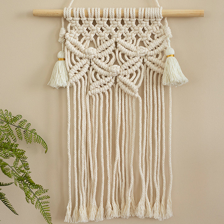 Handmade macrame wall hanging with long tassels and wooden rod