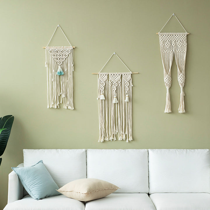 Handmade macrame wall hanging with long tassels and wooden rod