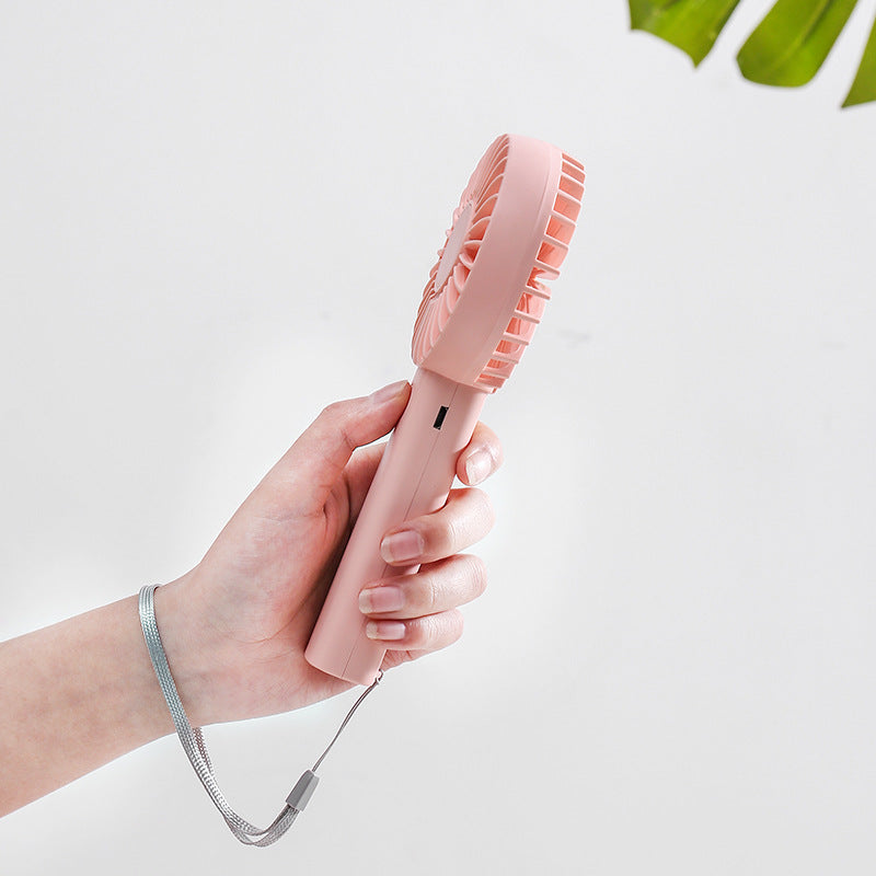 Unisex portable battery-operated mini hand fan with one-button operation and protected fan grill Kalsten