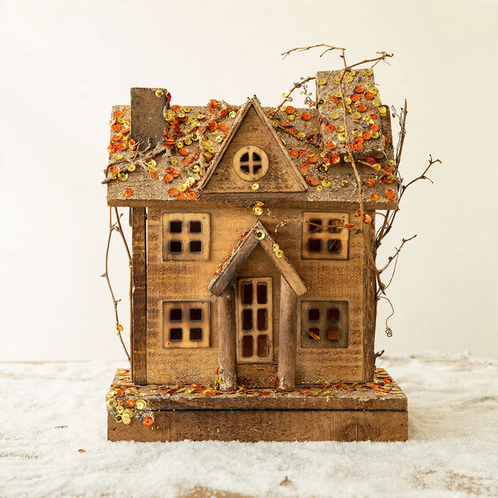 Illuminated wooden snow house in European style