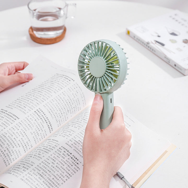 Unisex portable battery-operated mini hand fan with one-button operation and protected fan grill Kalsten