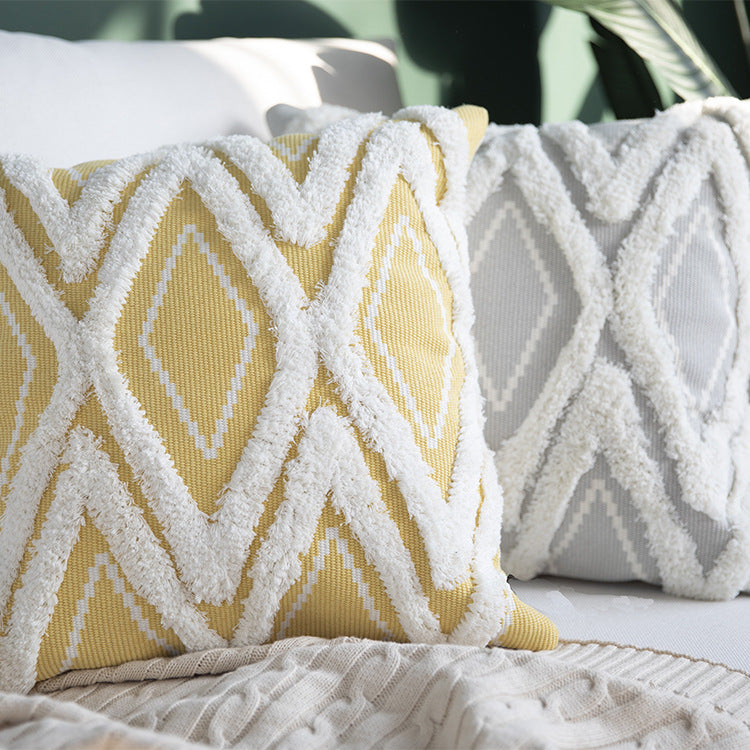 Decorative cushion cover with hand-tufted diamond relief and soft bouclé application