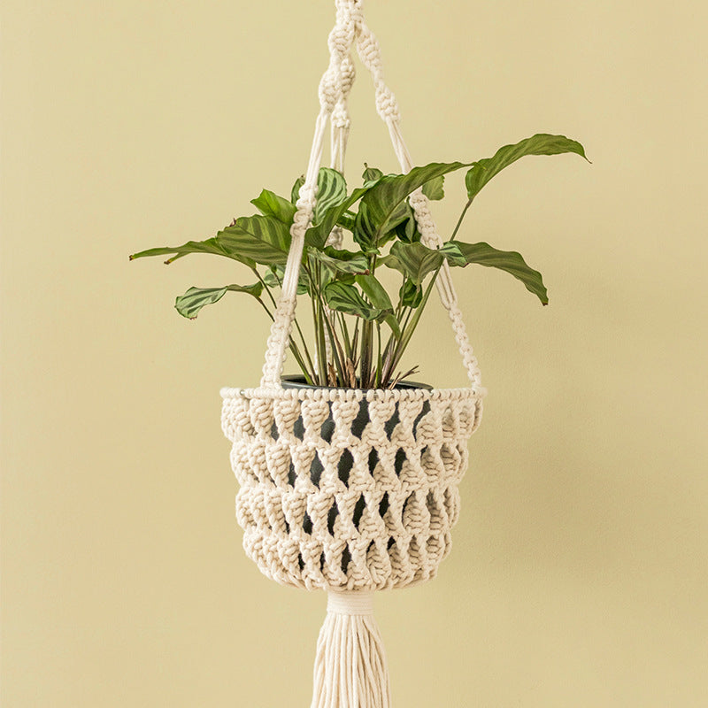 Macramé hanging planter with hand-knotted basket structure and decorative tassel
