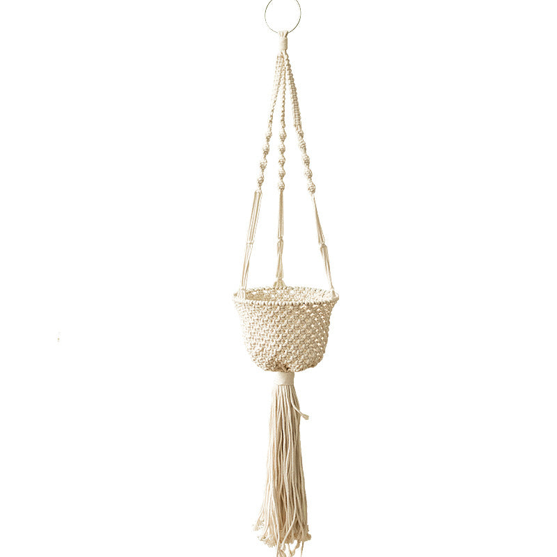 Macramé hanging planter with hand-knotted basket structure and decorative tassel
