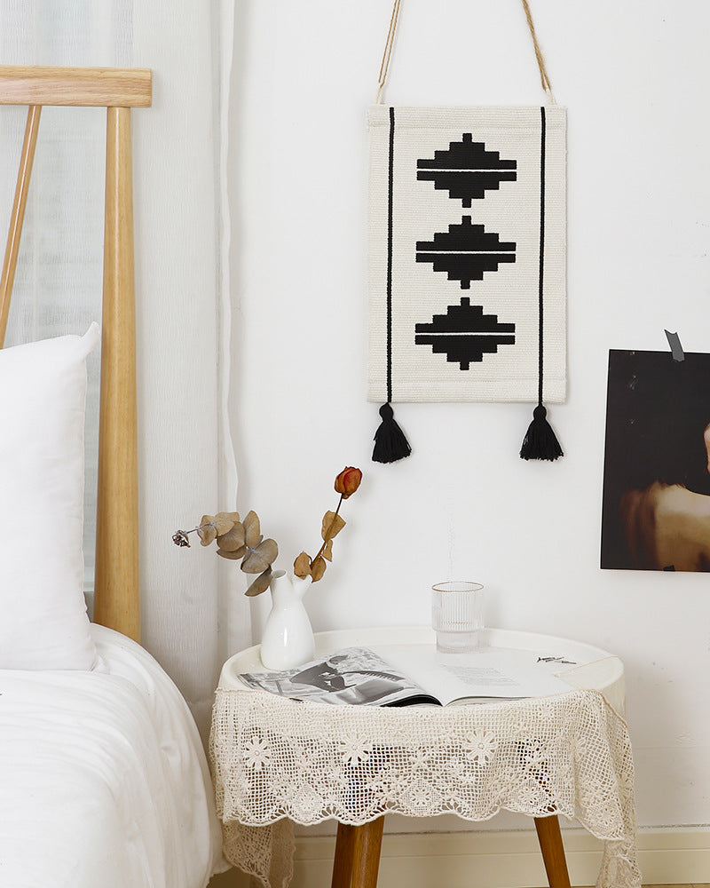 Woven wall hanging in minimalist geo pattern with decorative tassels and hanging loops