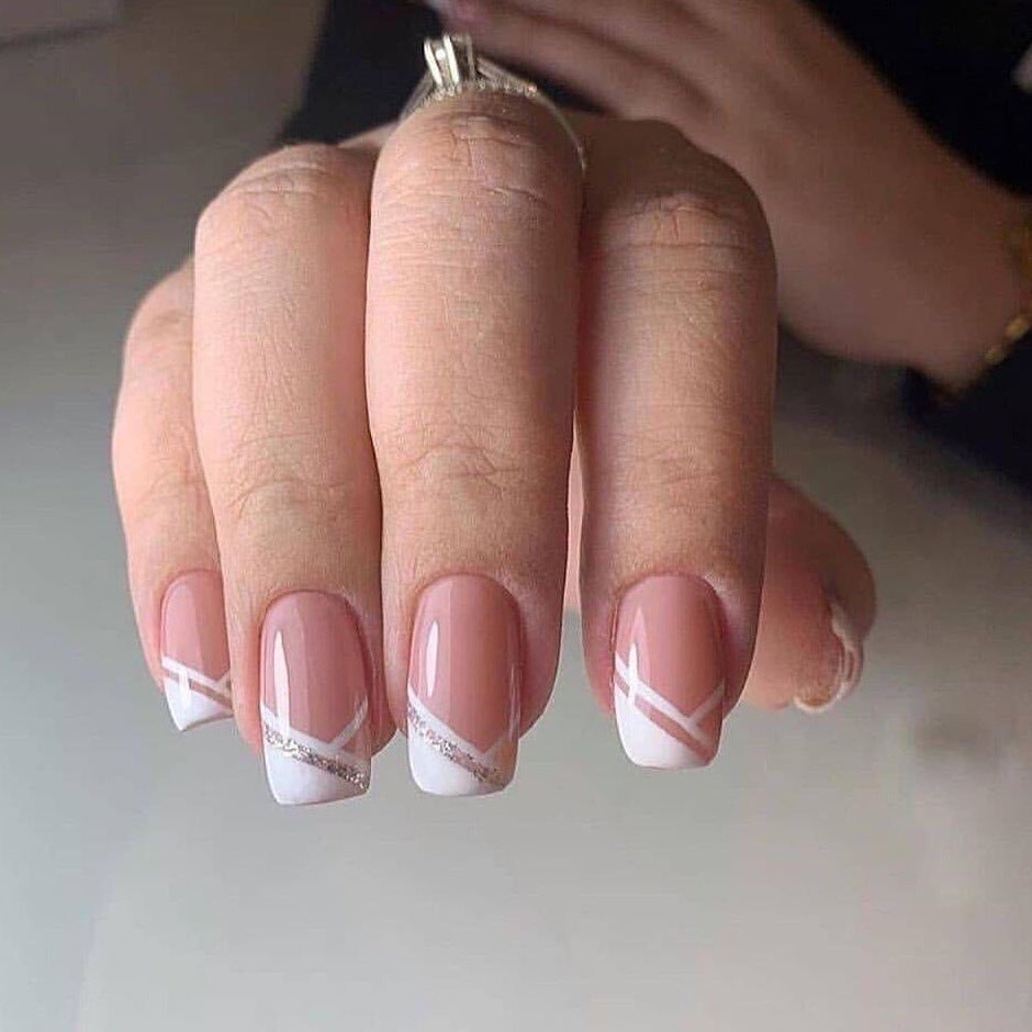 Artful nail design with elegant French tip and glitter accents Kalsten