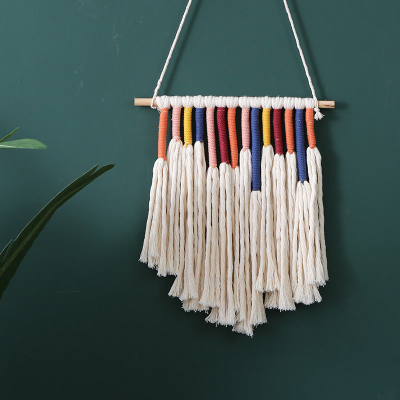 Handcrafted macrame wall hanging with colorful cotton fringes and wooden rod