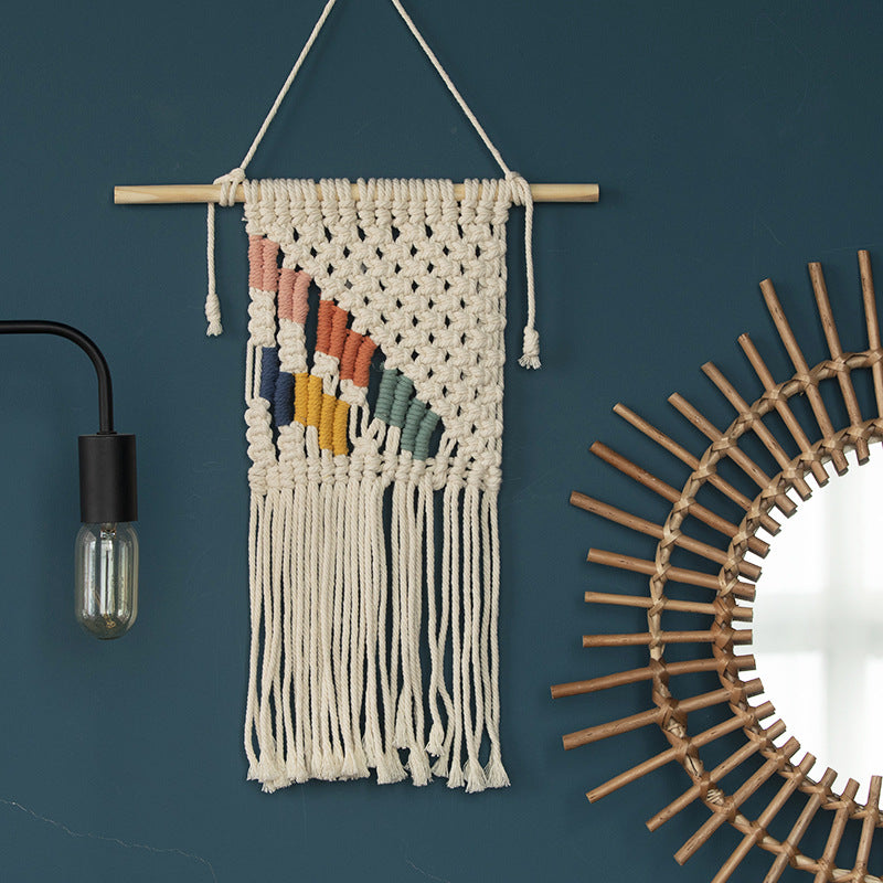 Handcrafted macrame wall hanging with colorful cotton fringes and wooden rod