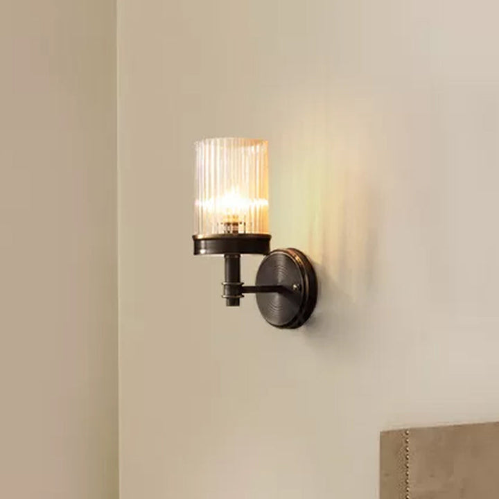 1-Light Wall Mounted Lamp Traditional Cylinder Transparent Glass Sconce Light in Brown/Gold over Bed | Kalsten