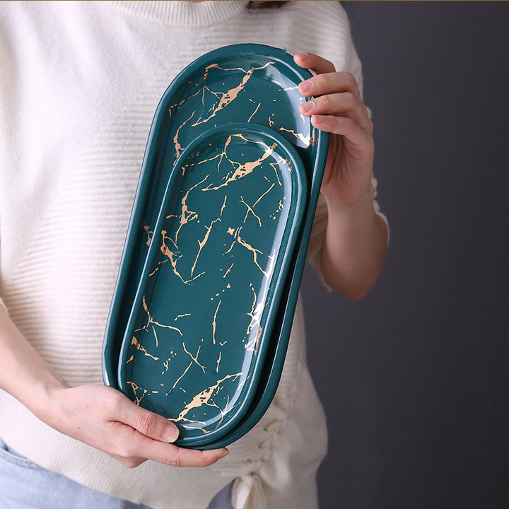 Oval serving tray made of melamine with glossy marble look and raised edge