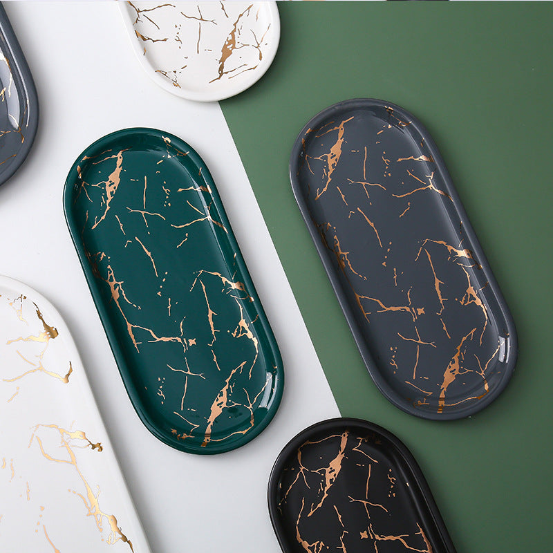 Oval serving tray made of melamine with glossy marble look and raised edge