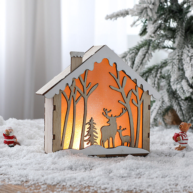 Illuminated wooden Christmas house in Scandinavian style