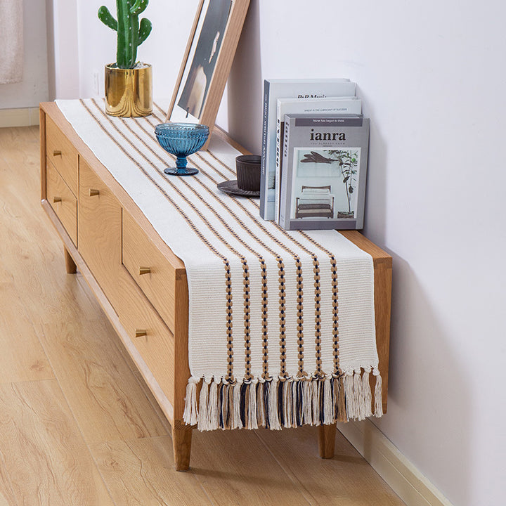 Decorative table runner in Scandinavian-minimalist design with macrame fringes Kalsten