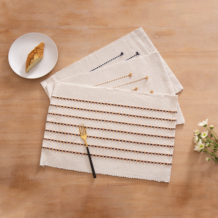 Woven placemats and table runners made of cotton blend with fine dot stripes and knot applications Kalsten