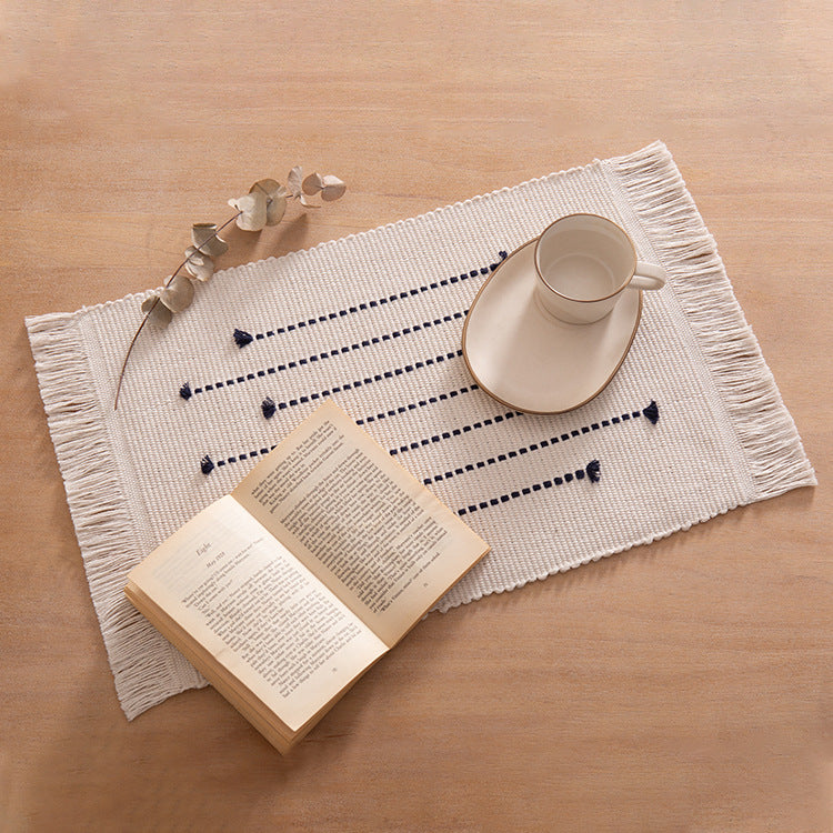Woven placemats and table runners made of cotton blend with fine dot stripes and knot applications Kalsten