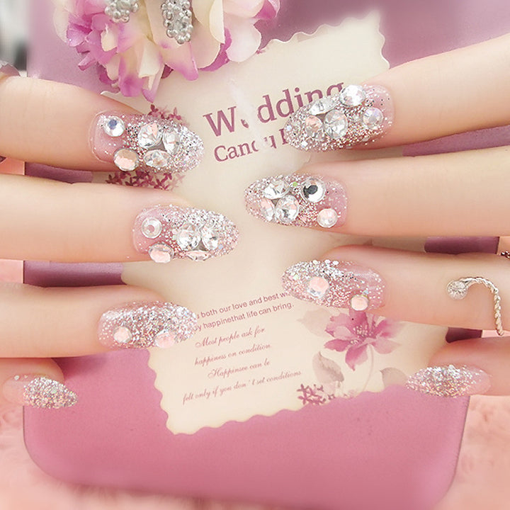 Artificials nails with sparkling rhinestone accents and elegant flower embellishments Kalsten