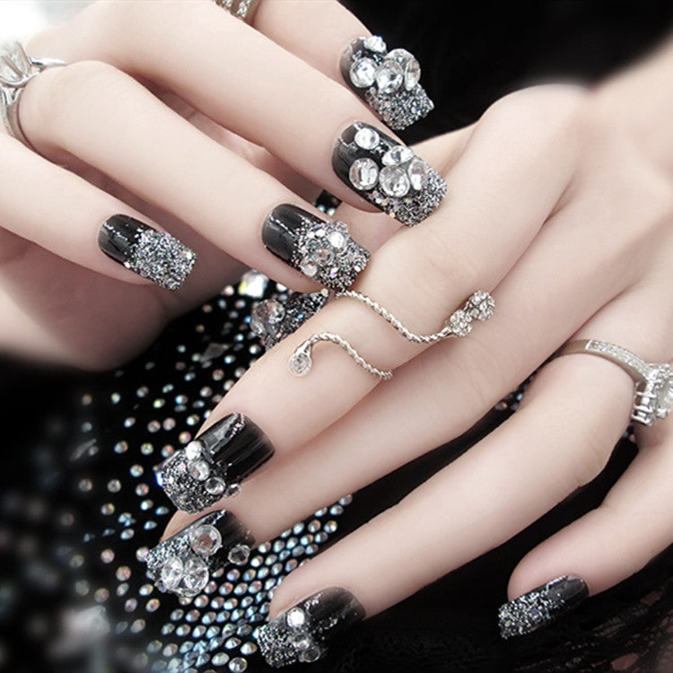 Artificials nails with sparkling rhinestone accents and elegant flower embellishments Kalsten