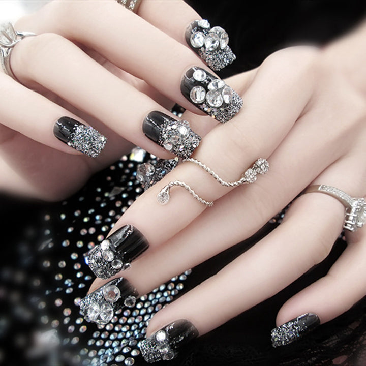 Artificials nails with sparkling rhinestone accents and elegant flower embellishments Kalsten