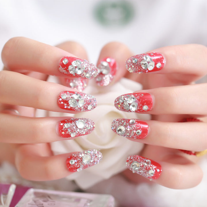 Artificials nails with sparkling rhinestone accents and elegant flower embellishments Kalsten