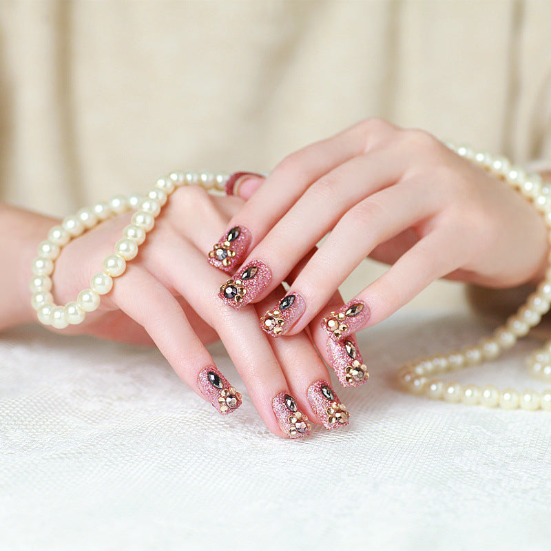 Glamorous artificial nails with glitter and jewelry decoration Kalsten
