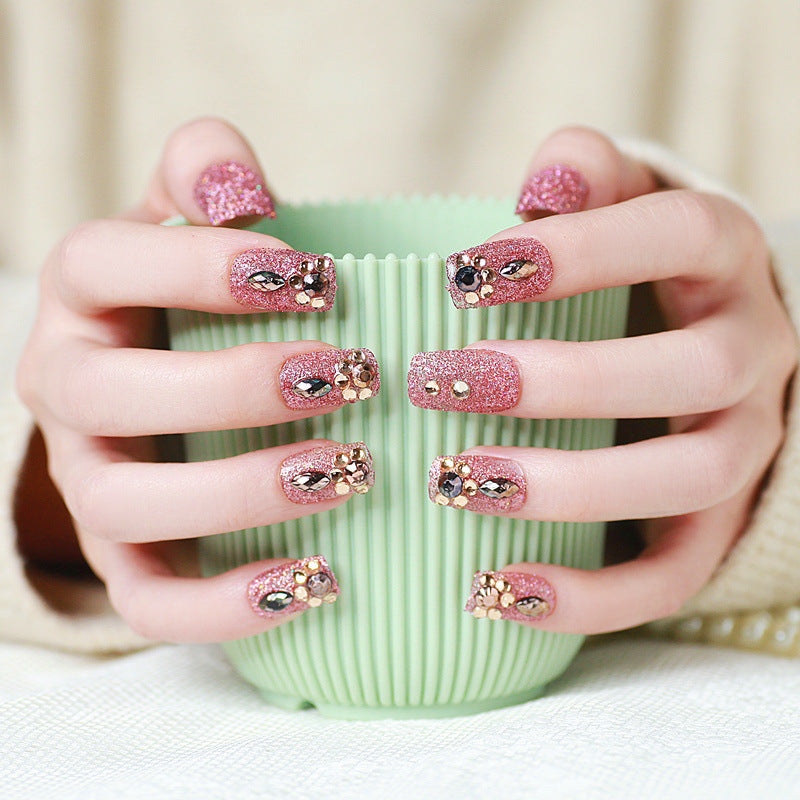Glamorous artificial nails with glitter and jewelry decoration Kalsten