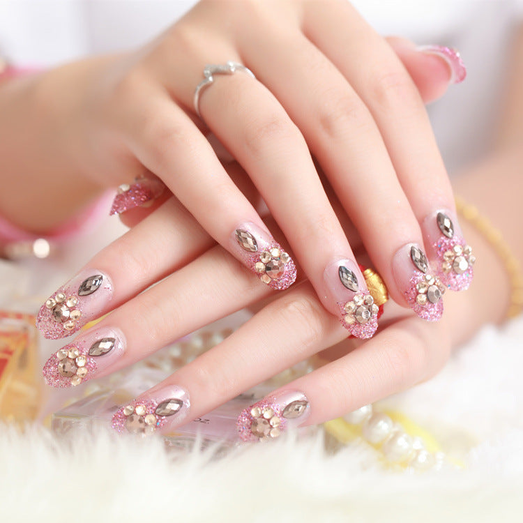 Glamorous artificial nails with glitter and floral elements Kalsten