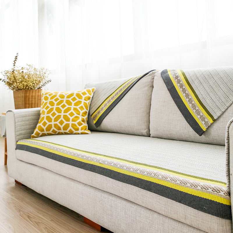 Handwoven table runner made of cotton blend with woven decorative border and striped texture