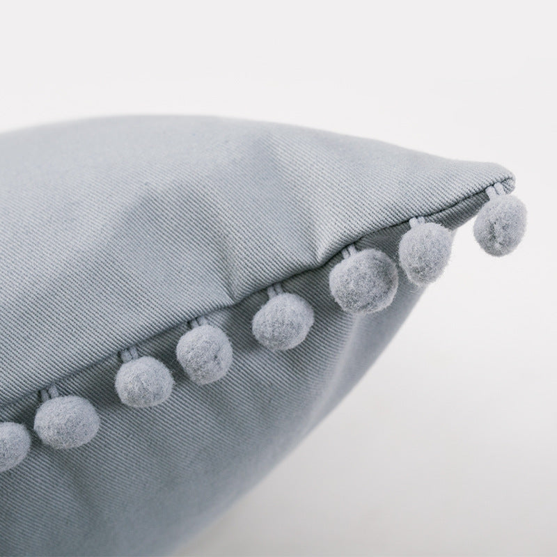 Decorative cushion cover with pompom border made of cotton-linen blend