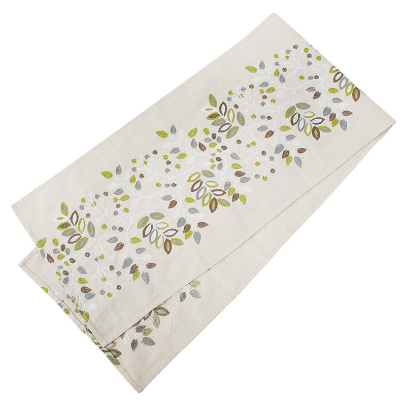 Decorative table runner made of a cotton-linen blend with botanical leaf print