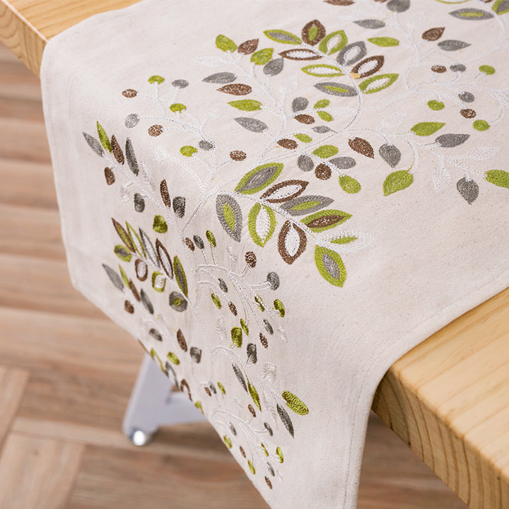 Decorative table runner made of a cotton-linen blend with botanical leaf print