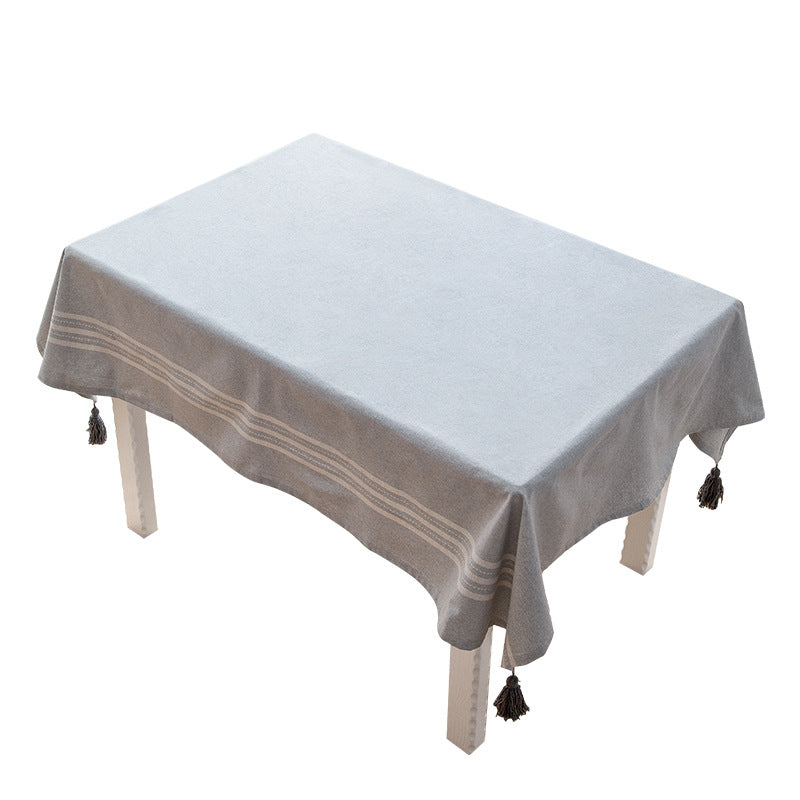 Rectangular tablecloth made of cotton-linen blend with subtle striped border and decorative tassels