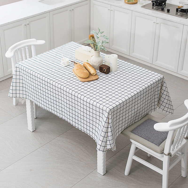 Round washable tablecloth with fine checkered grid pattern and wavy hem
