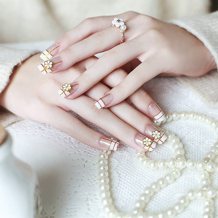 Artificial nails with elegant 3D flower accents and gold trim Kalsten