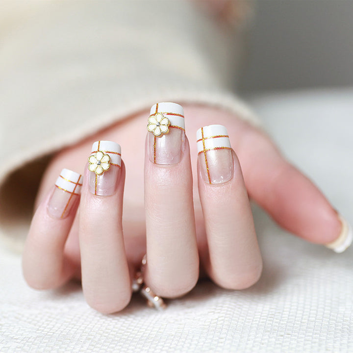 Artificial nails with elegant 3D flower accents and gold trim Kalsten