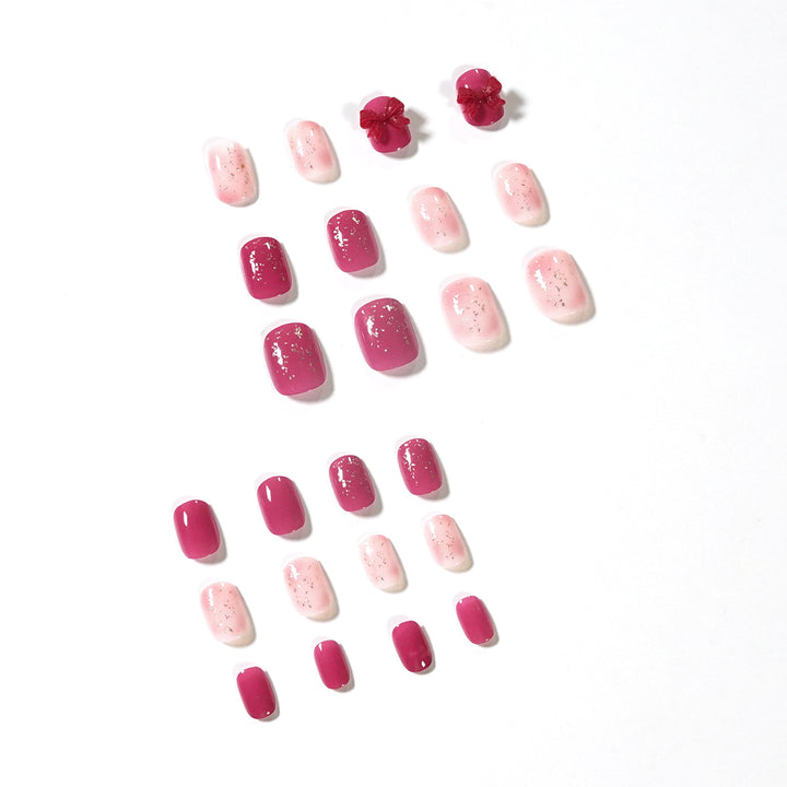 Artificial nail art with glitter embellishments and cute bow motif Kalsten