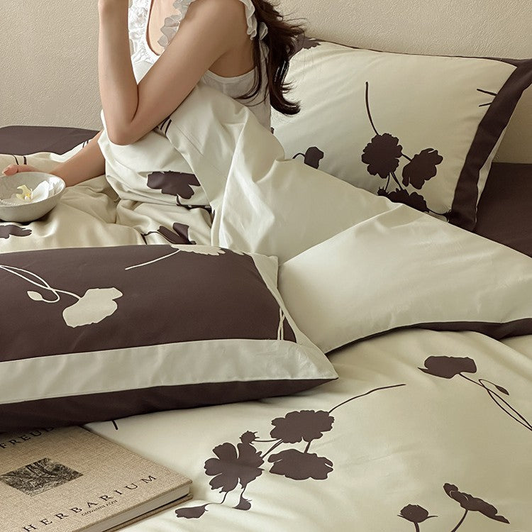 Reversible cotton satin bedding set with floral silhouette print and contrasting piped edge