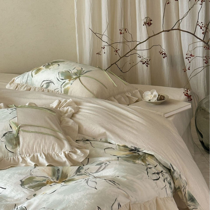 Duvet cover set made of cotton satin with watercolor magnolia print, ruffle, and tie ribbons