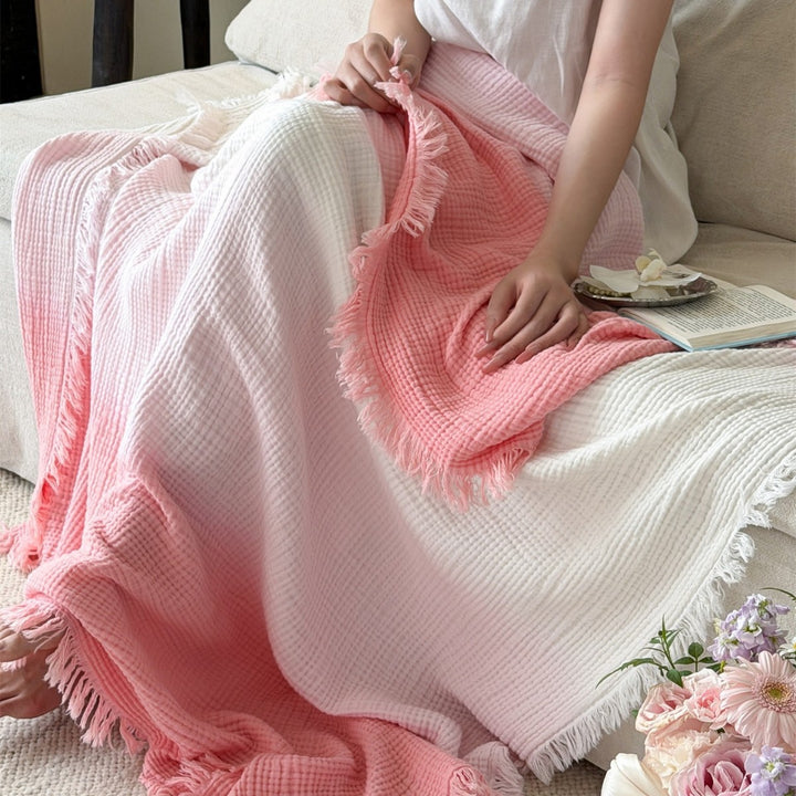 Large waffle blanket with ombre coloring and decorative fringes
