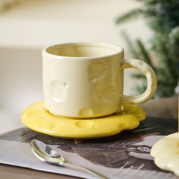 Sculptural ceramic cup set with flowing glaze and textured saucer