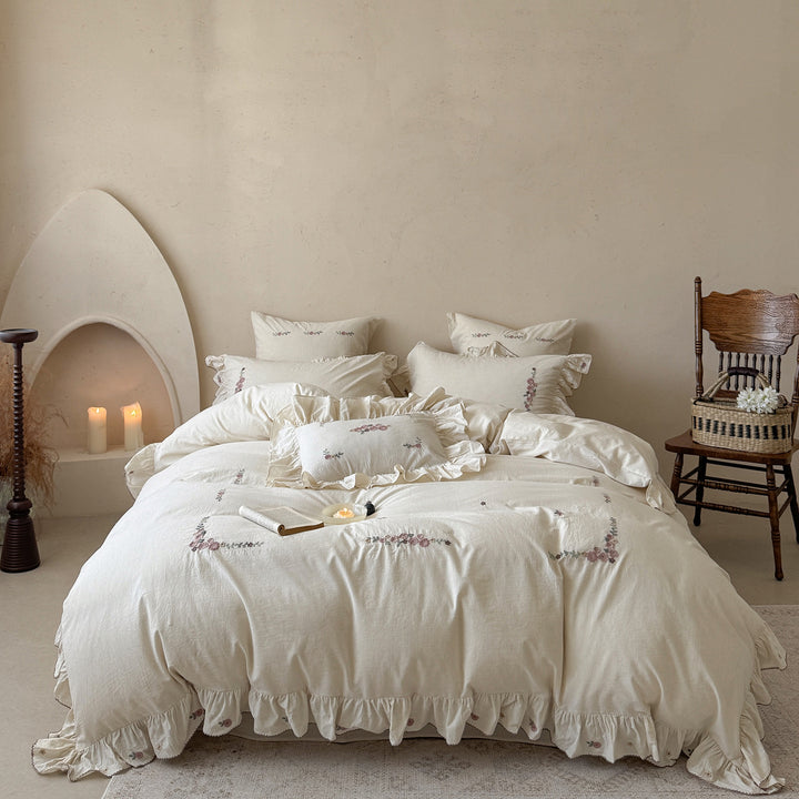 Bedding set in natural linen style with delicate rose garland embroidery and ruffled trim