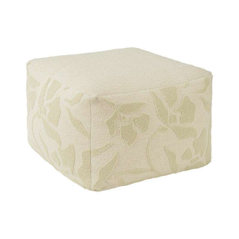 Square floor sitting pouf with textured bouclé surface and floral relief
